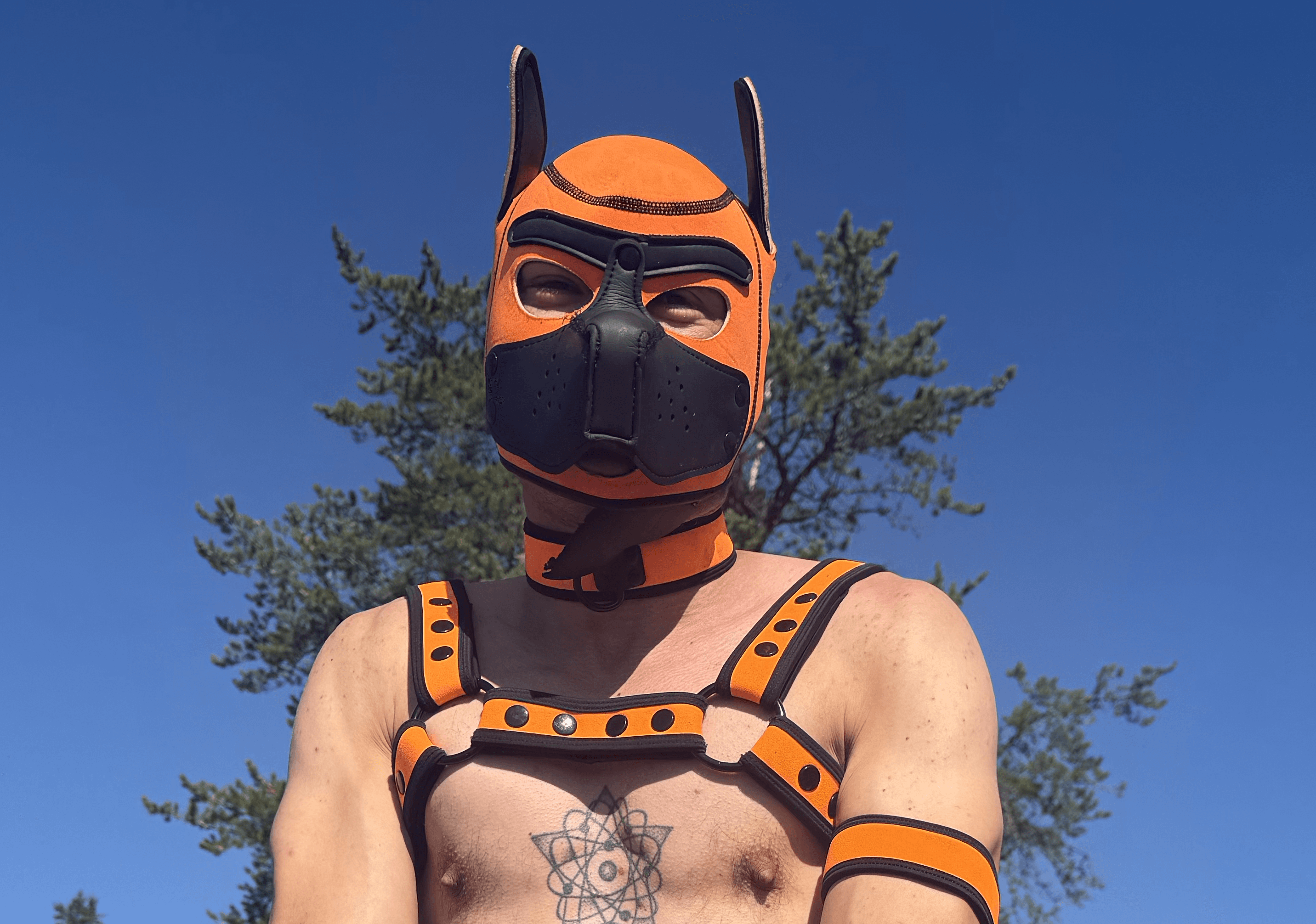 Portrait in an orange mask under a blue sky